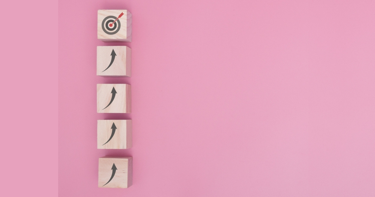 Wood blocks with arrows aiming at target.