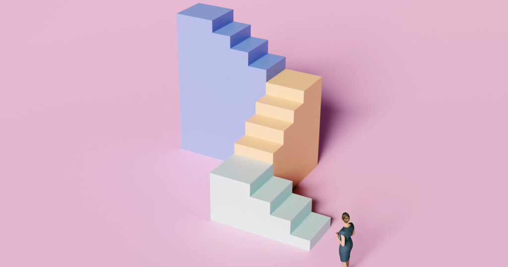 Person near colorful abstract stairs on pink background.