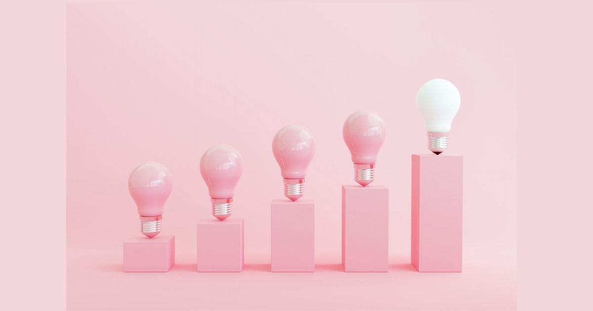 Five light bulbs on ascending pink blocks