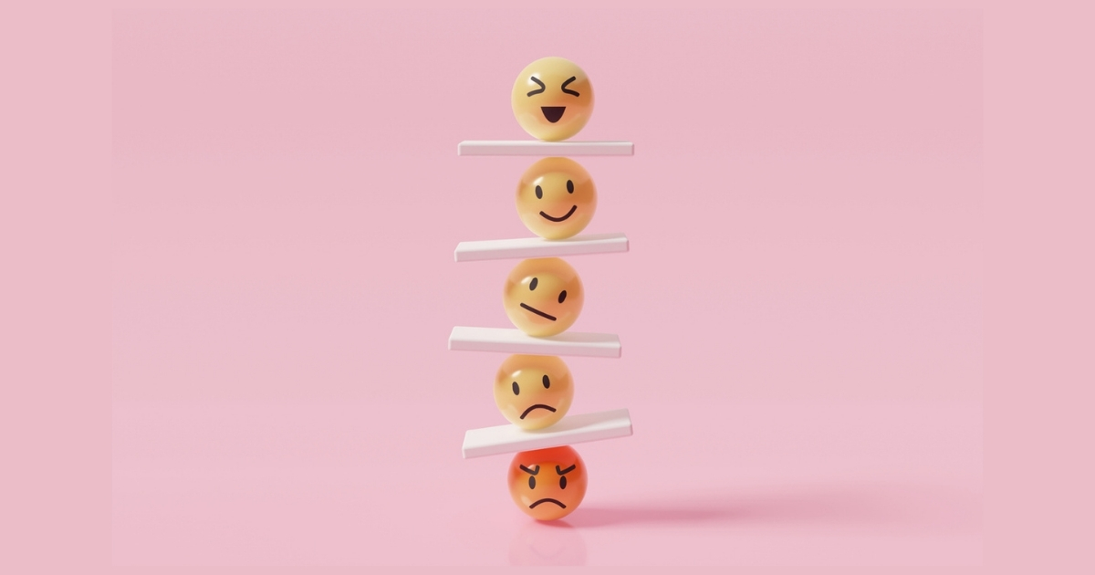 Stacked emojis showing different emotions on pink background.