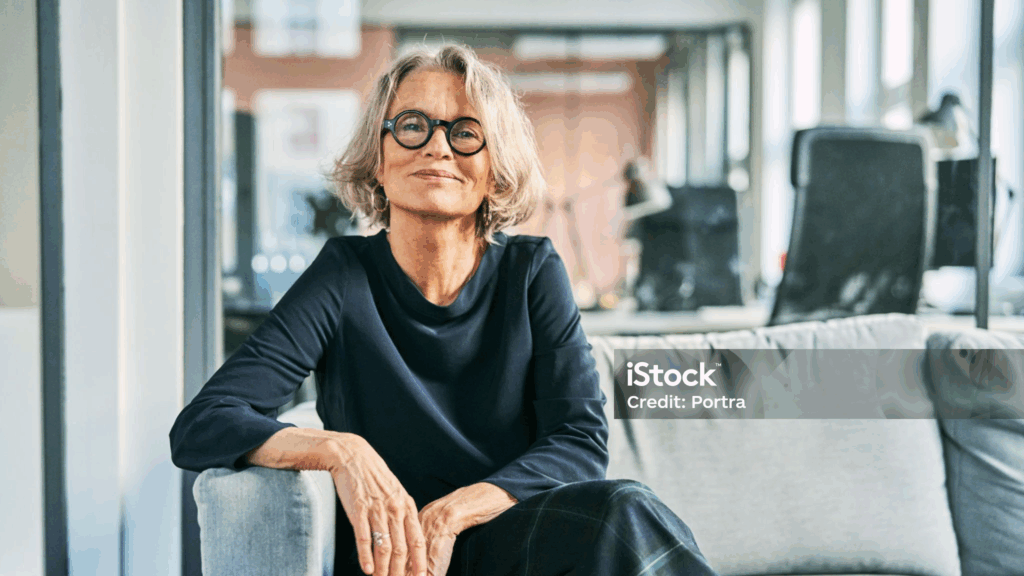 Confident woman sitting in modern office space.
