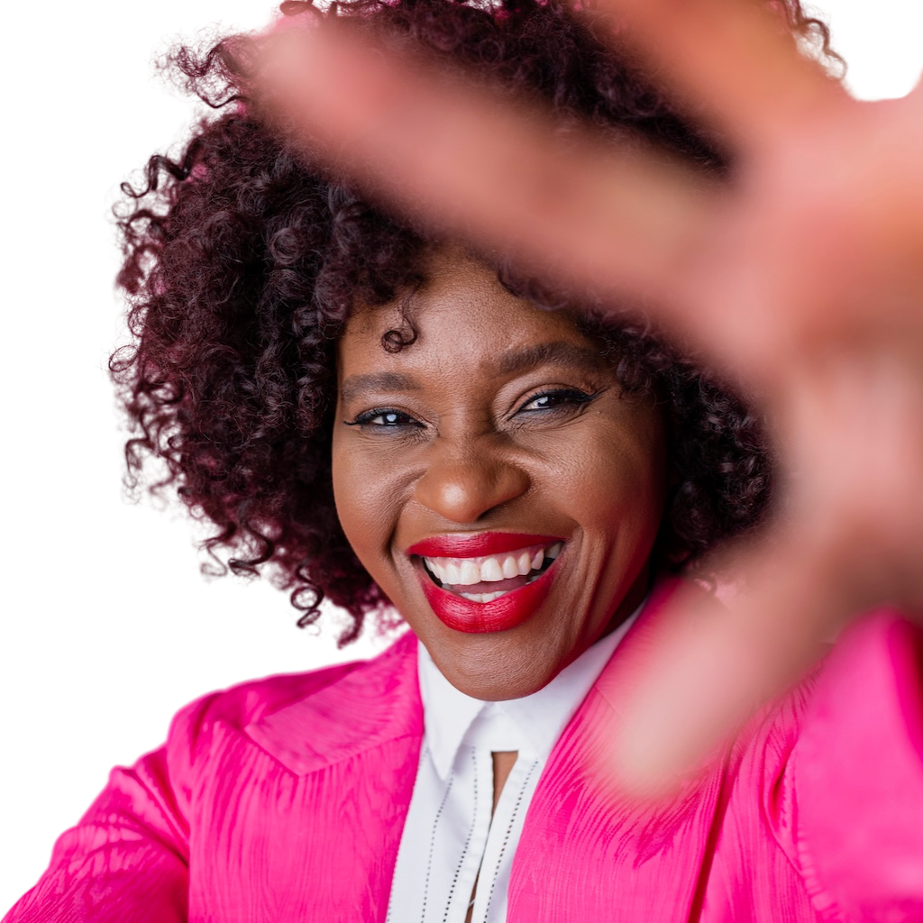 Smiling woman in pink reaching towards camera.