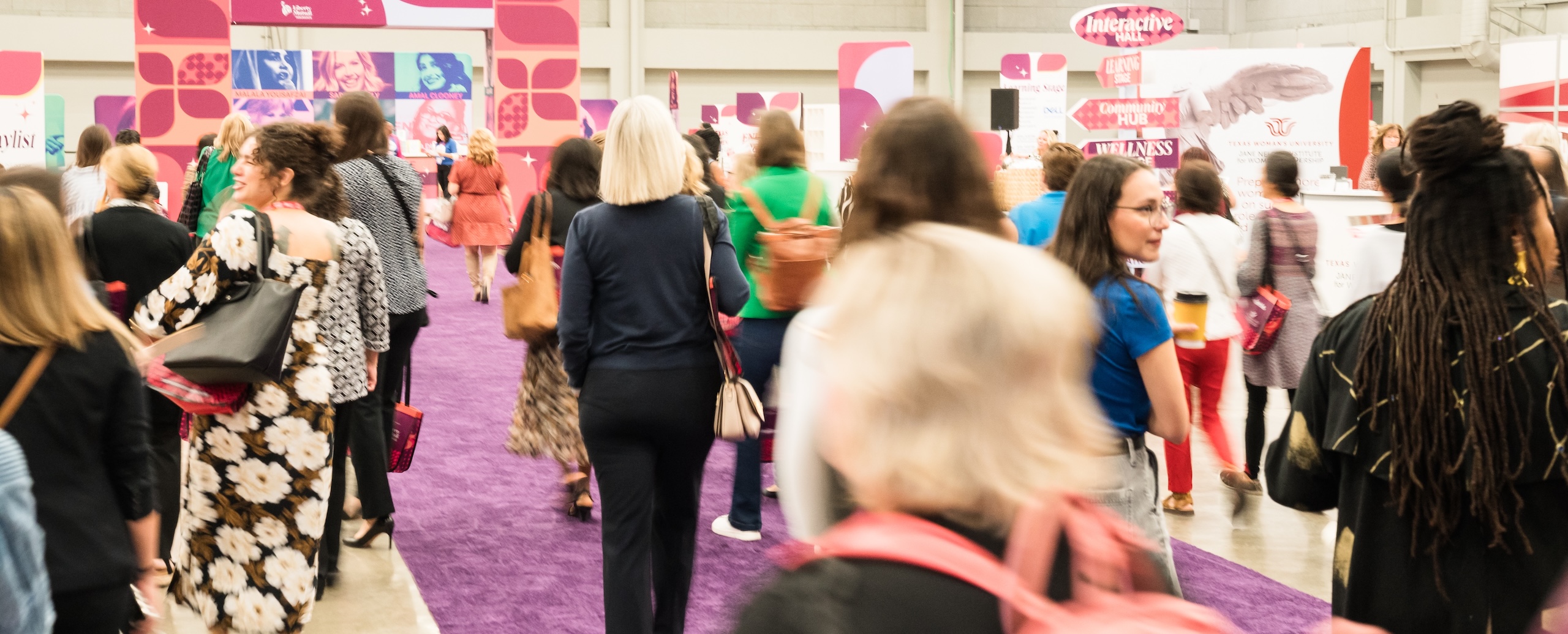Crowd at a women's expo exhibit hall.